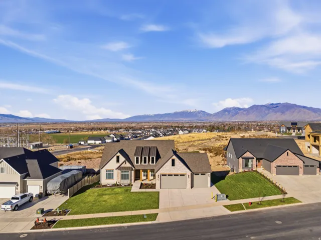 Modern farmhouse style home featuring a residential view, concrete driveway, a mountain view, and a garage