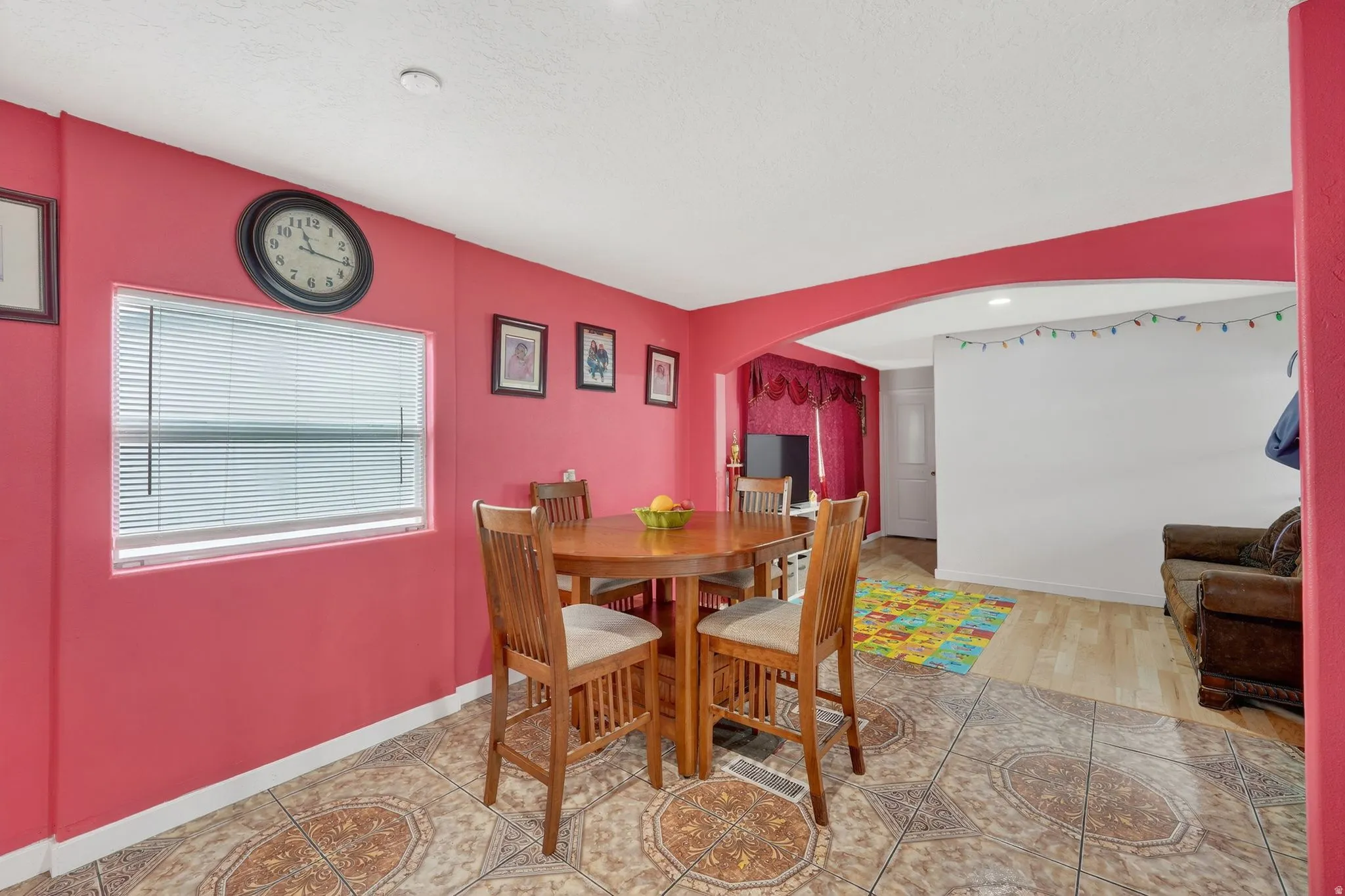 Dining room featuring arched walkways and baseboards