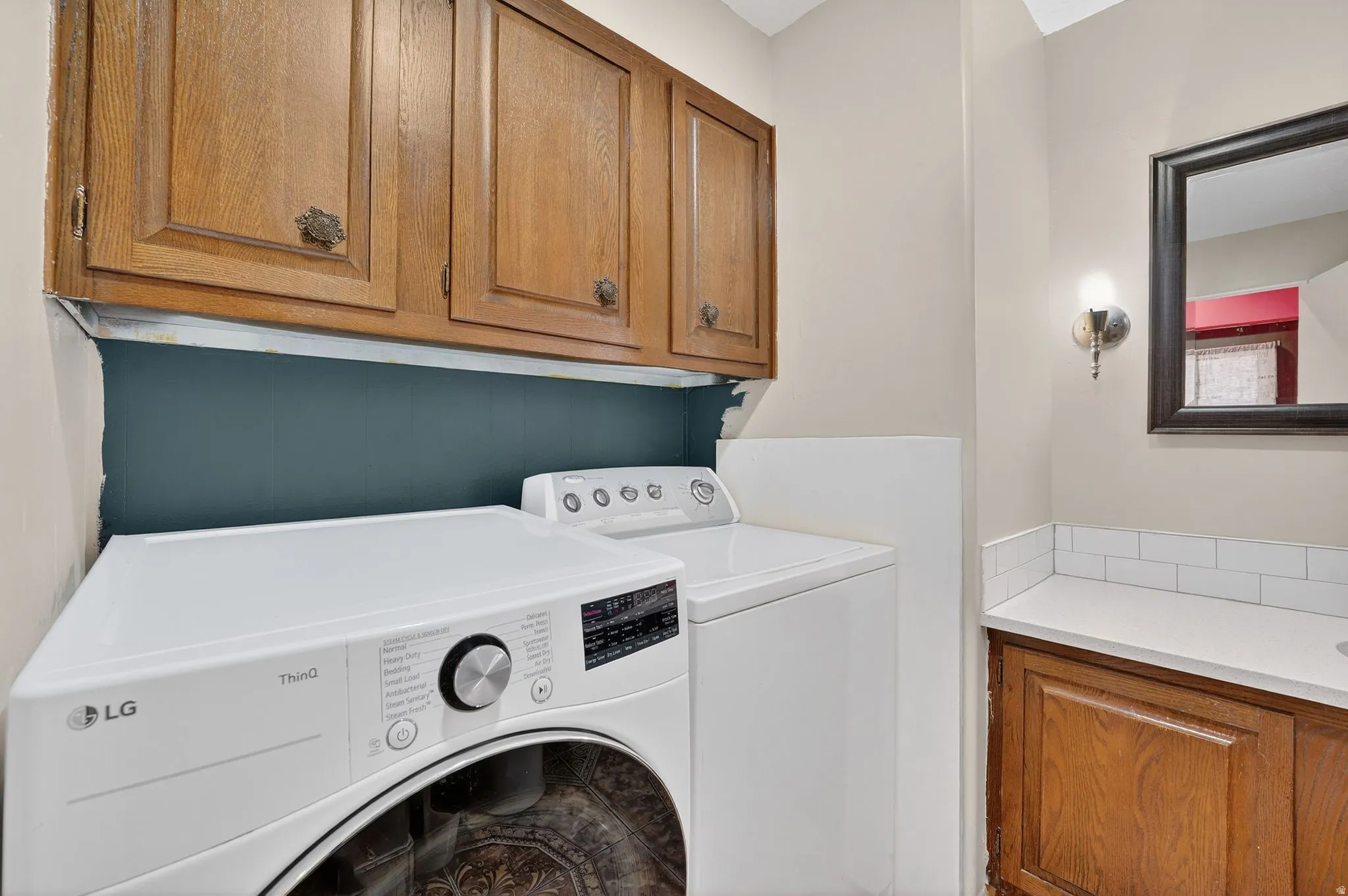 Laundry room featuring washing machine and dryer and cabinet space