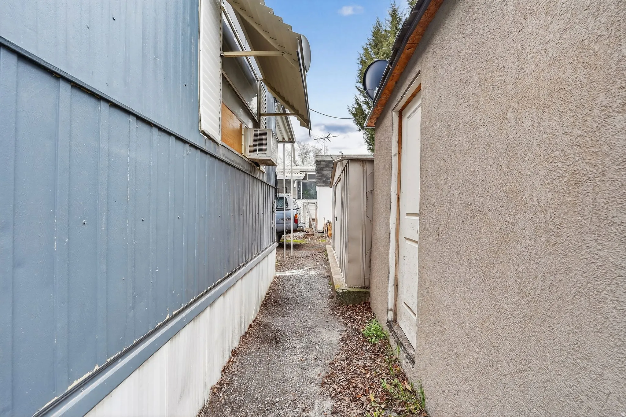 View of side of home featuring stucco siding