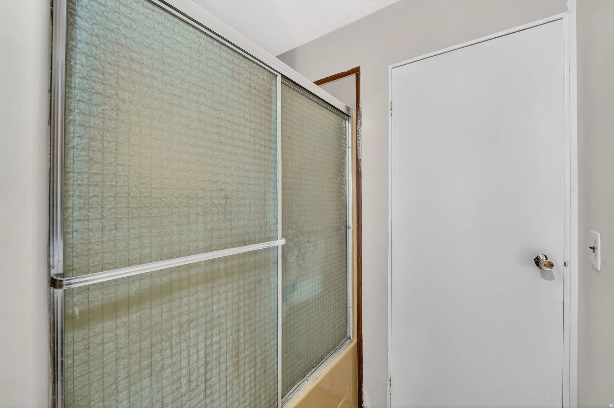 Bathroom with shower / bath combination with glass door