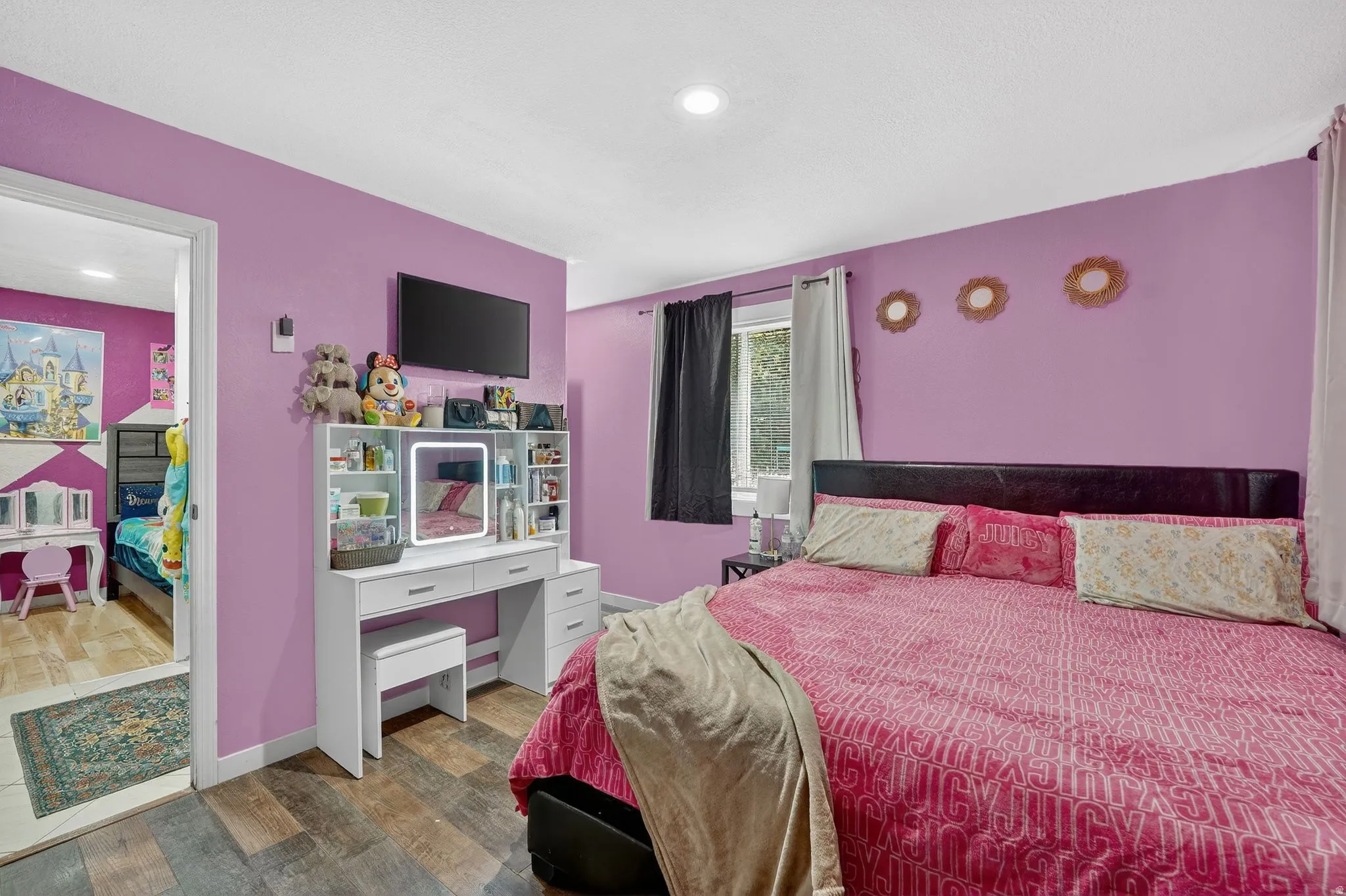 Bedroom featuring dark wood-style floors and a desk