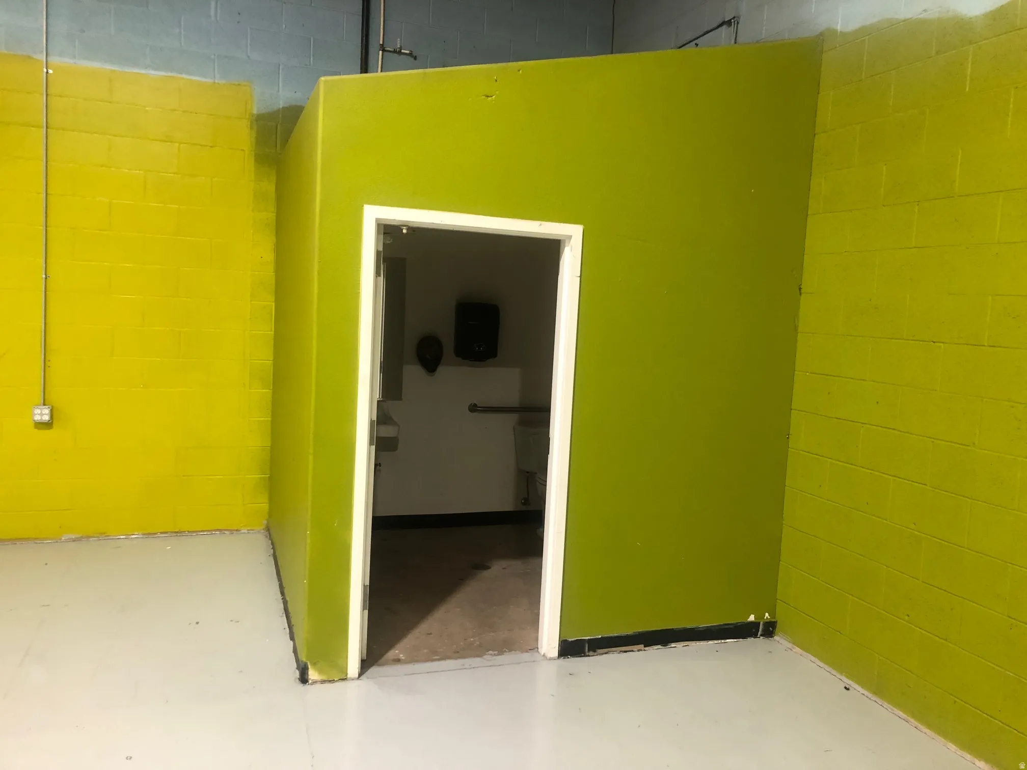 Spare room with concrete block wall and concrete floors