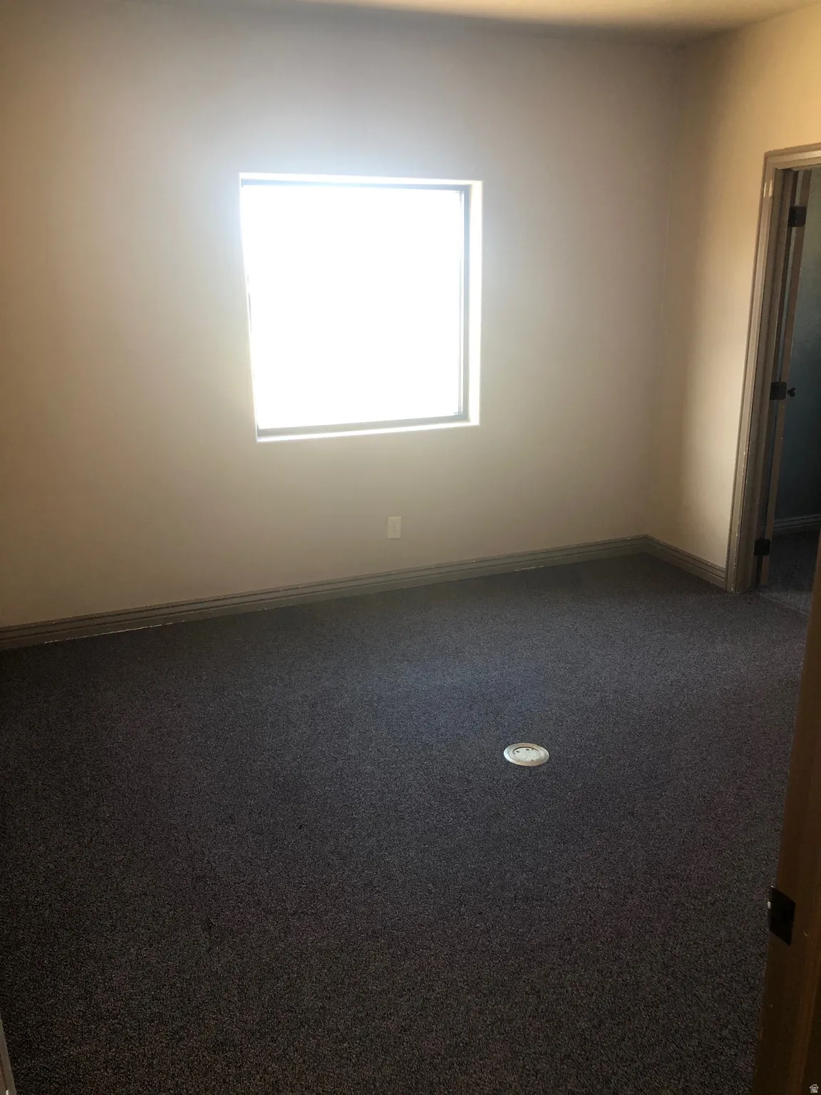 Spare room with carpet and baseboards