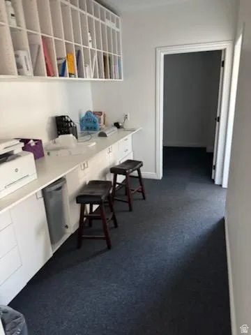 Office space featuring dark colored carpet