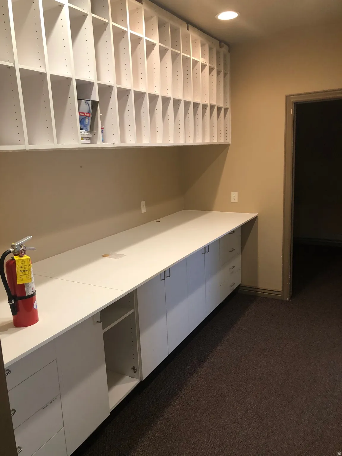 Kitchen featuring white cabinets, dark carpet, light countertops, and recessed lighting