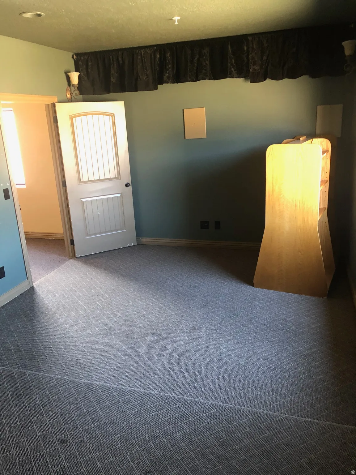 Unfurnished room featuring dark carpet and baseboards