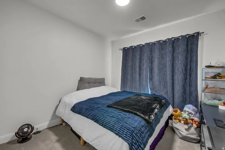 Carpeted bedroom with baseboards