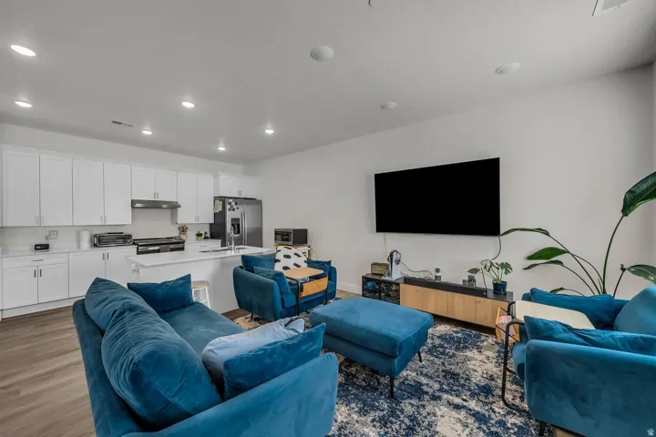 Living room with dark wood-style floors and recessed lighting