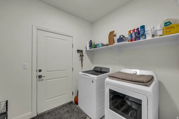 Laundry area with washing machine and clothes dryer
