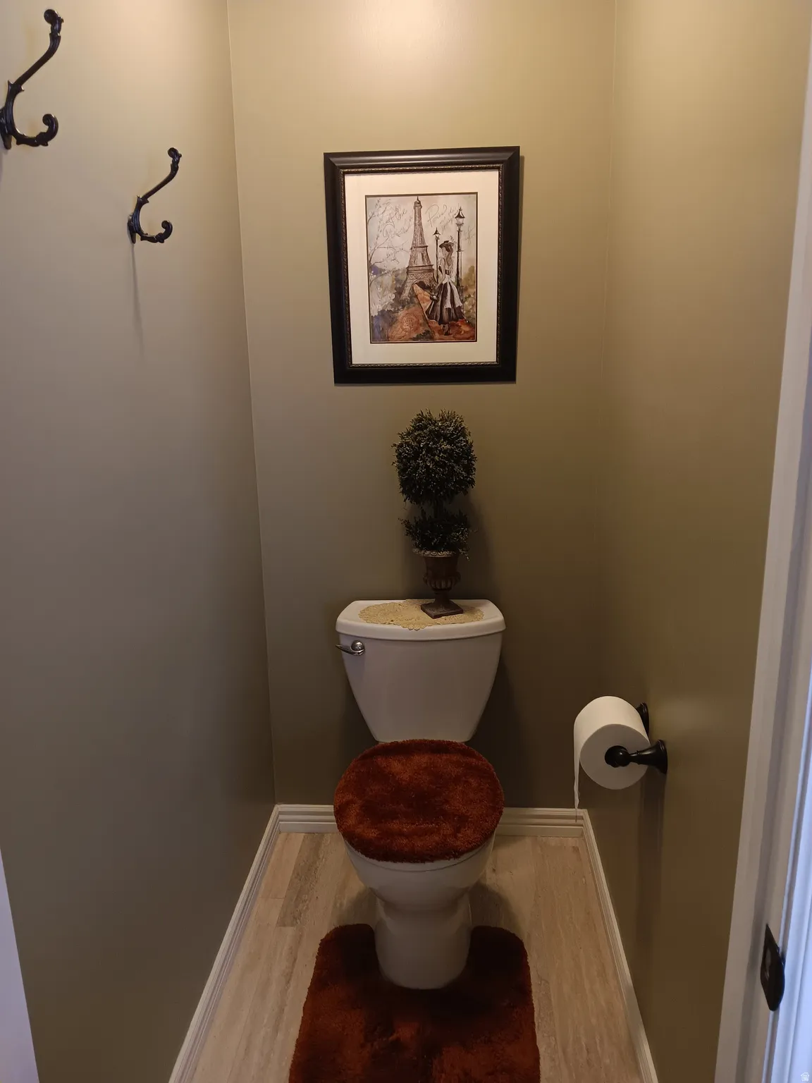 Bathroom with toilet and wood finished floors