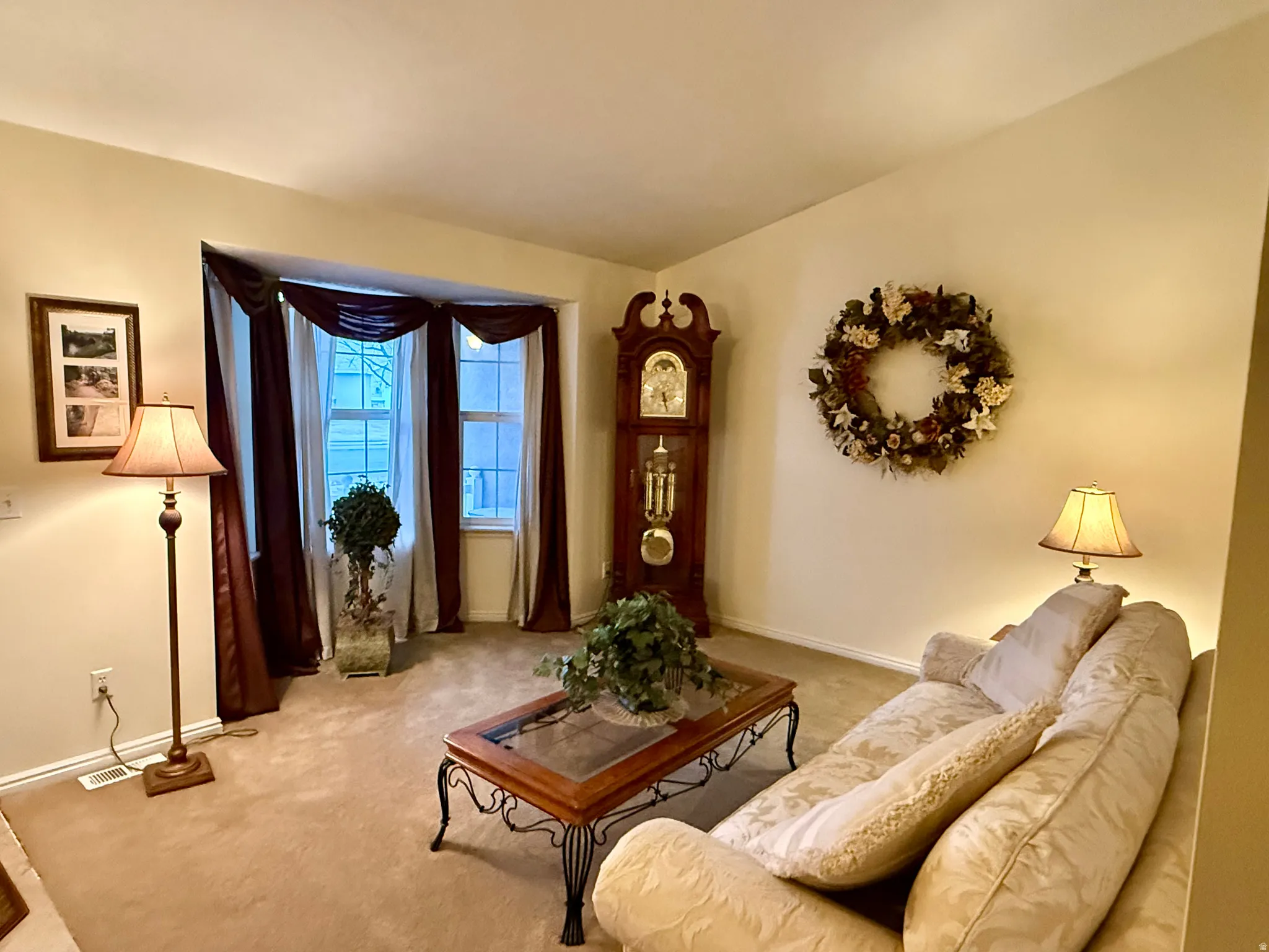 Carpeted living area featuring baseboards