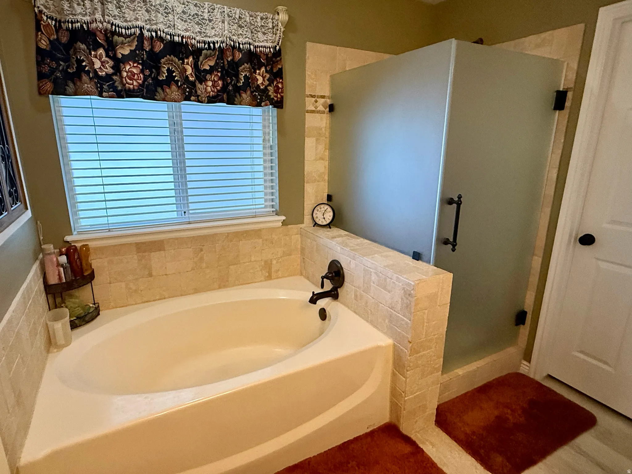 Bathroom with a bath and a shower stall