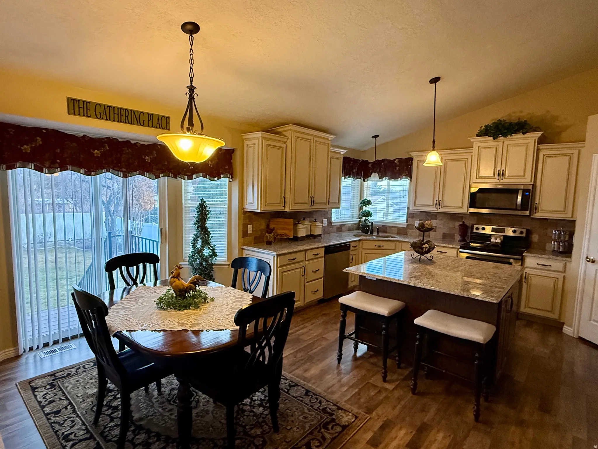 Dining space featuring dark wood-type flooring and lofted ceiling