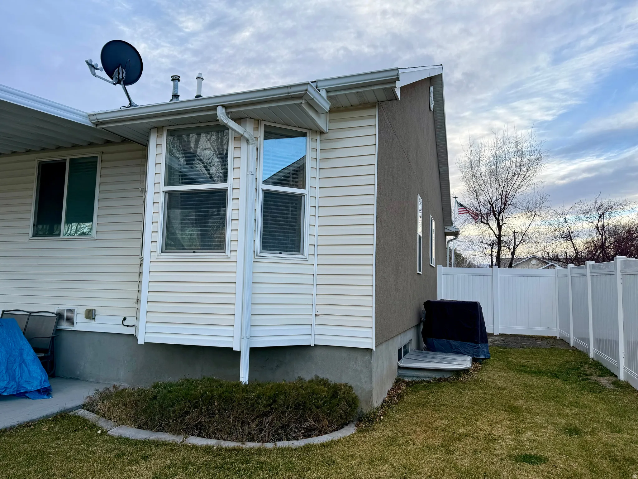 View of side of home with a fenced backyard and a patio