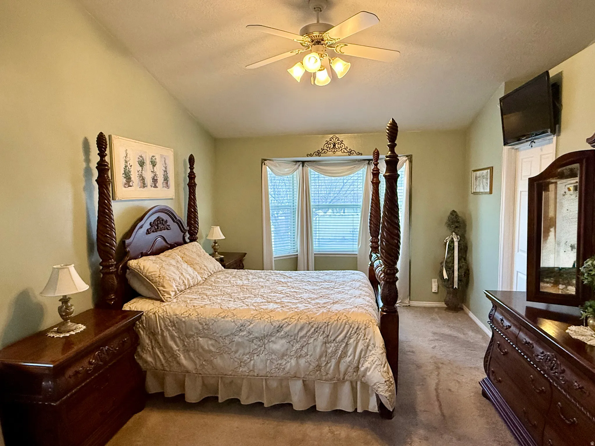 Bedroom with carpet flooring, a ceiling fan, and vaulted ceiling