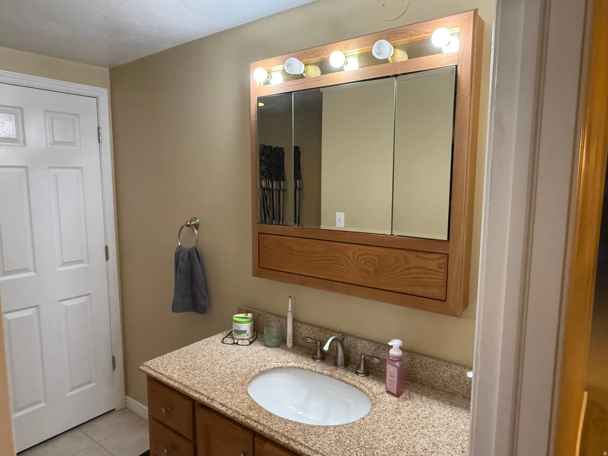 Bathroom with vanity and light tile patterned floors