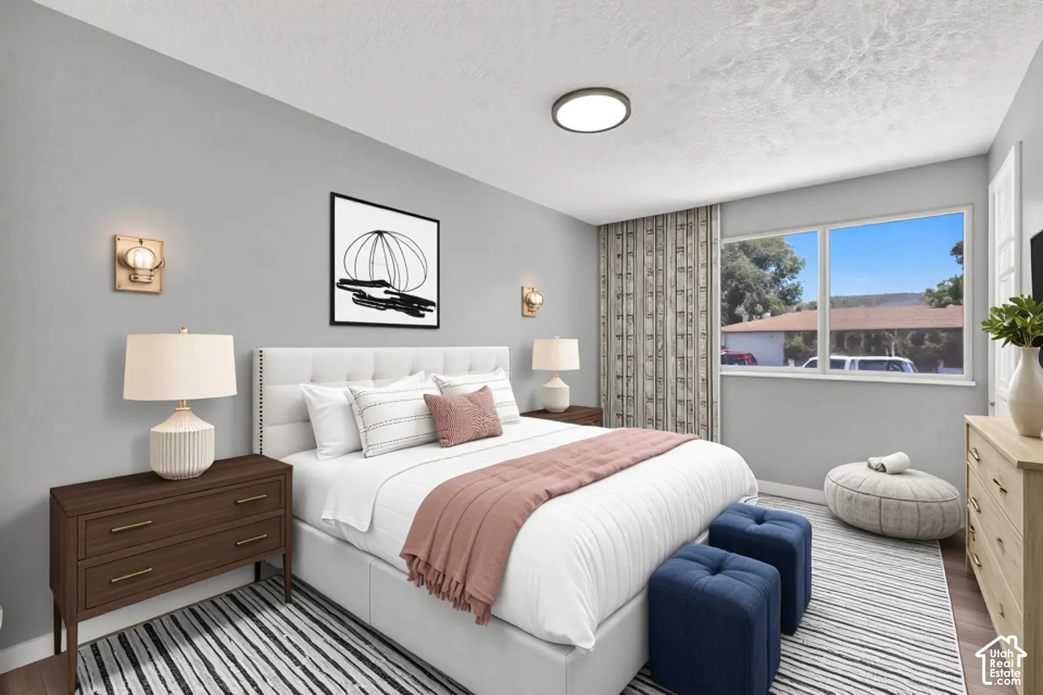 Bedroom with light gray painted walls with wood-finish flooring. Virtually staged to illustrate the home's potential.