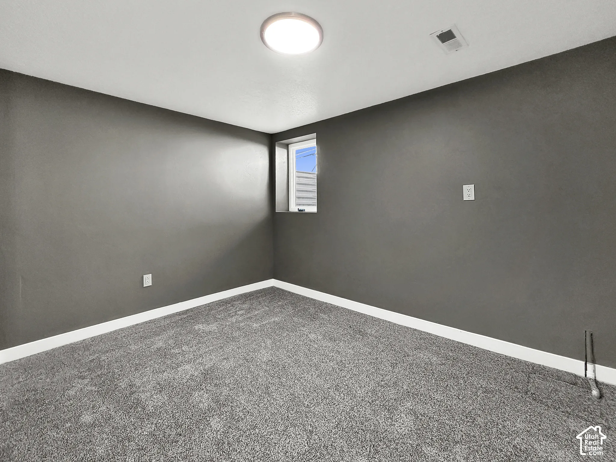 Recessed window, overhead flush-mount lighting, and wall-to-wall carpeting