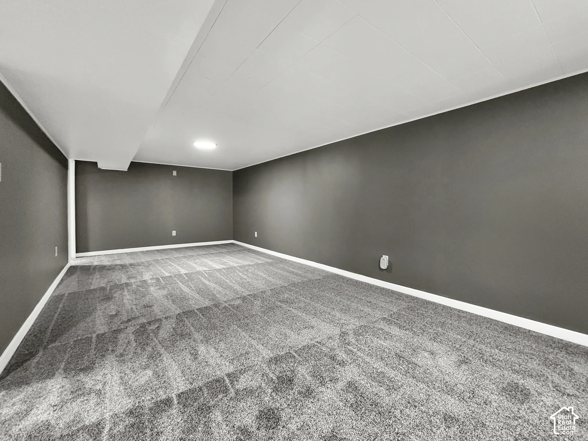 Recessed ceiling lighting, gray carpeting, dark gray wall paint, and white trim