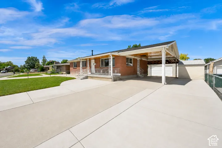 Brick exterior with a covered carport