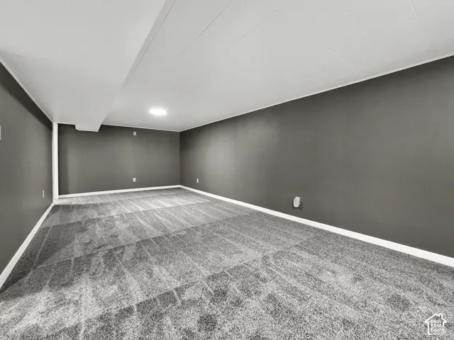 Recessed ceiling lighting, gray carpeting, dark gray wall paint, and white trim