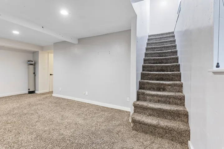 Stairway featuring carpet flooring, recessed lighting, and beam ceiling