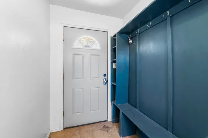 Mudroom featuring light tile patterned floors and baseboards
