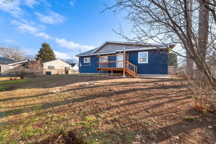 Back of house with a deck