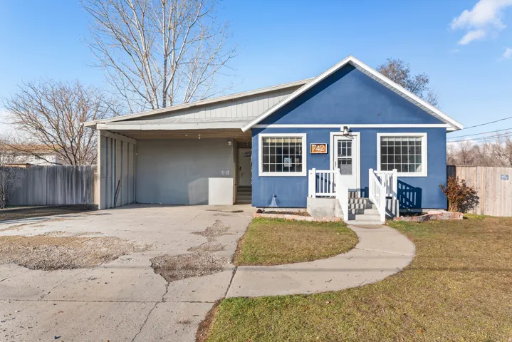Bungalow-style house with concrete driveway and a carport