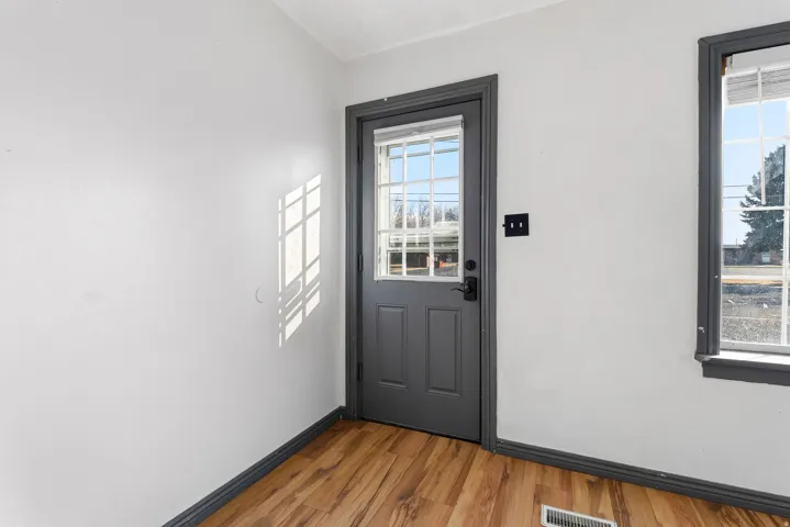 Entryway featuring baseboards and wood finished floors