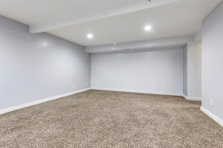 Finished below grade area featuring carpet floors and recessed lighting