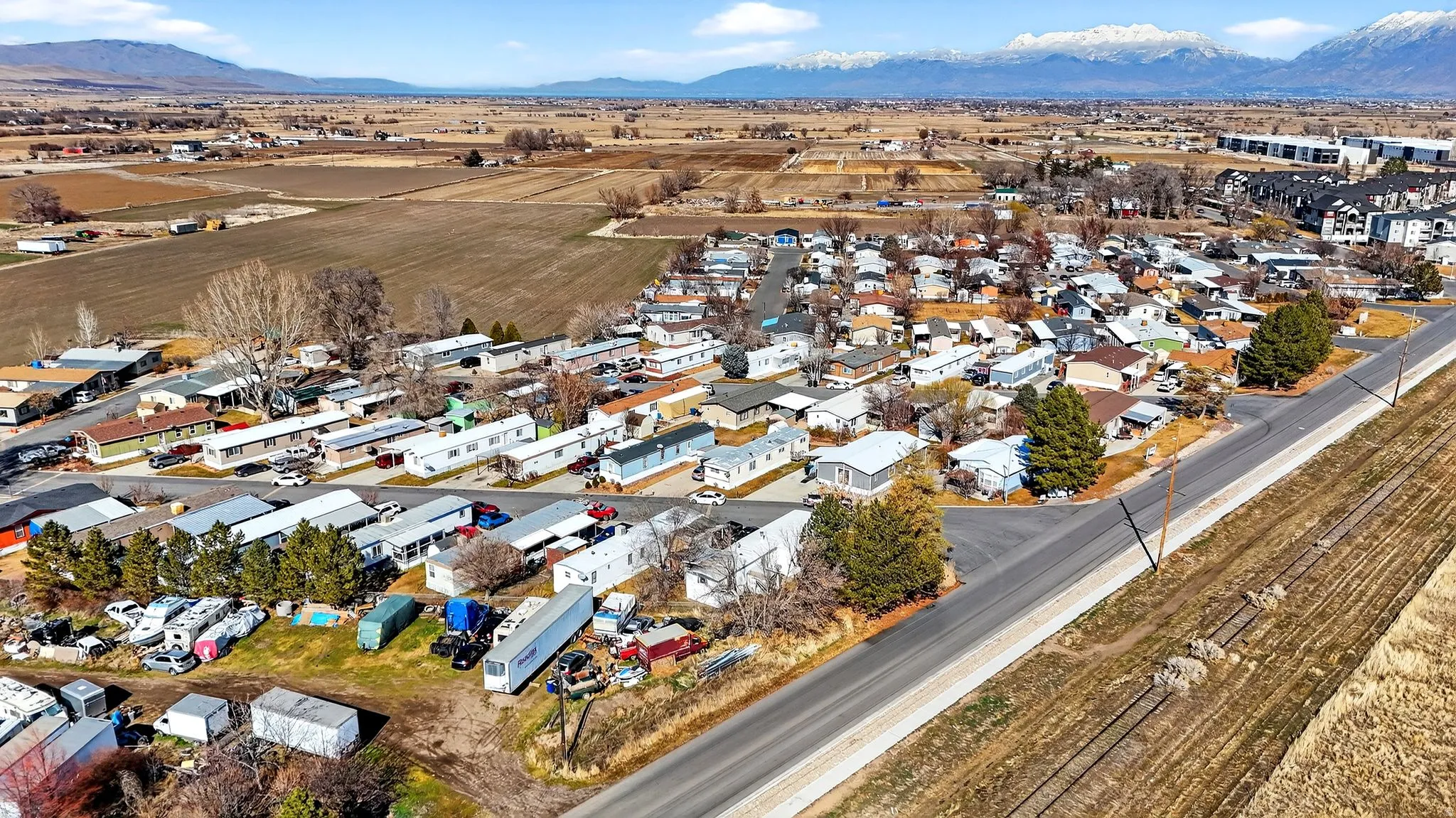 Aerial view of property's location with nearby suburban area and a mountain backdrop
