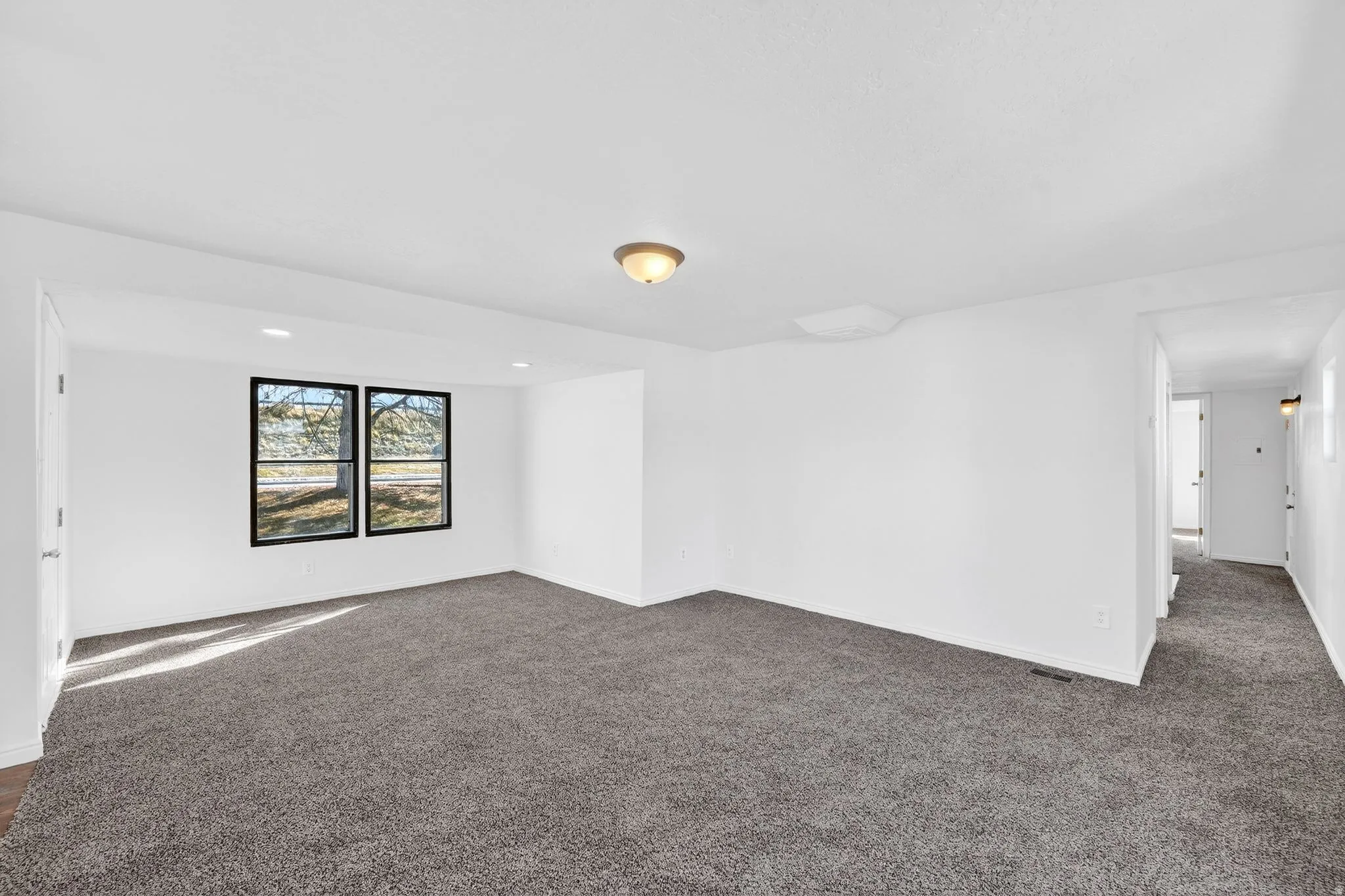 Unfurnished room with dark colored carpet