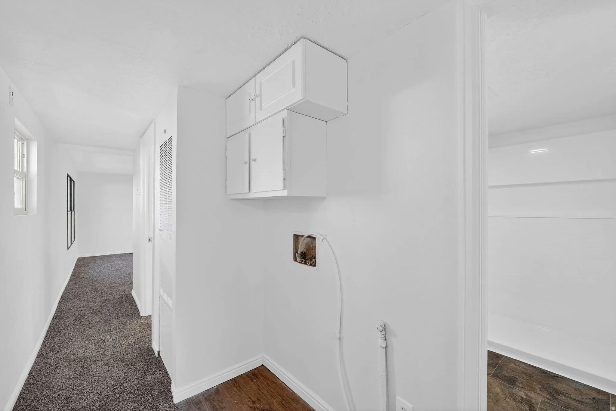 Laundry area featuring hookup for a washing machine and cabinet space
