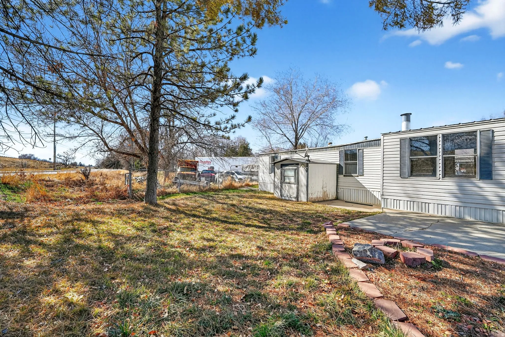 View of yard with a storage unit and a patio