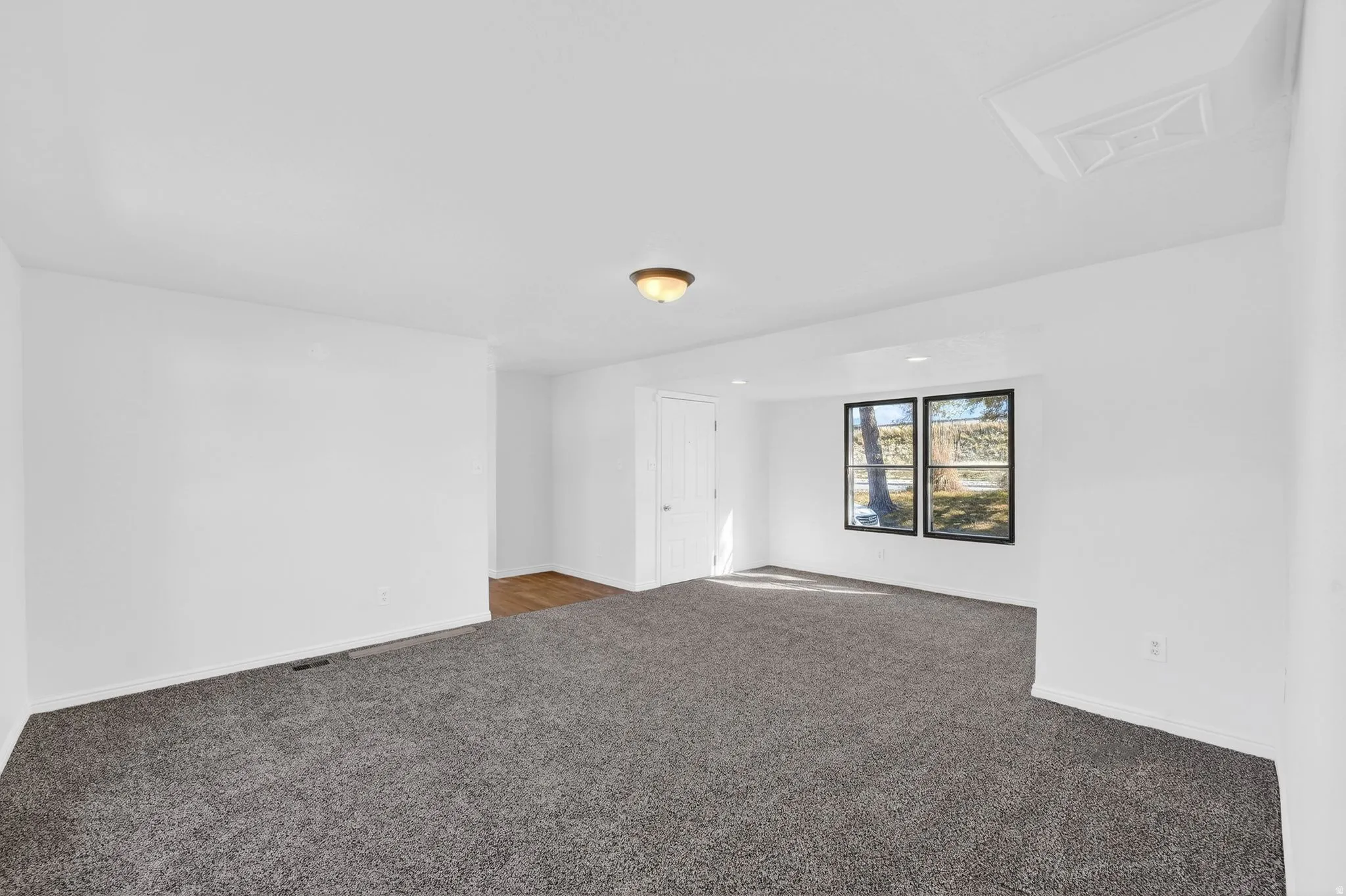 Carpeted empty room with baseboards