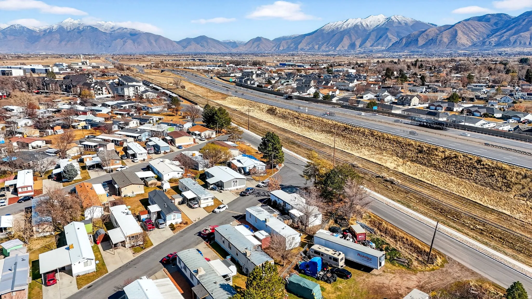 Aerial overview of property's location featuring nearby suburban area and a mountain backdrop