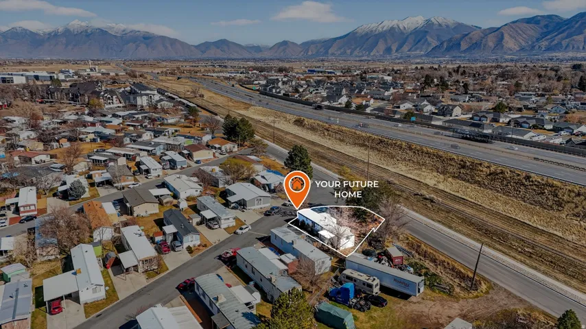 Aerial perspective of suburban area featuring a mountainous background and property parcel outlined