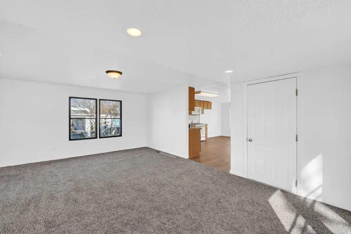 Carpeted empty room featuring a textured ceiling and recessed lighting