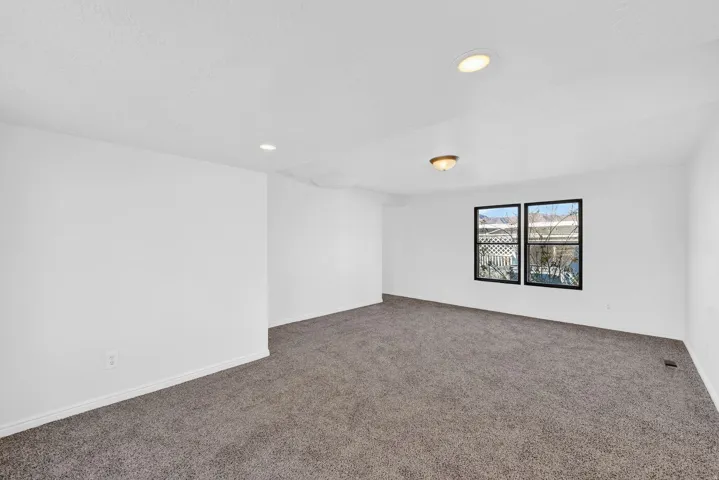 Empty room featuring carpet flooring and recessed lighting