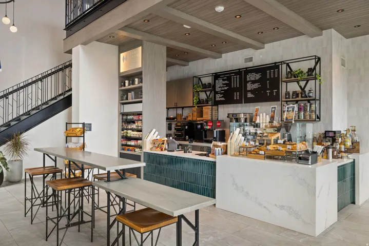 Bar with a wood ceiling with exposed beams and open shelves
