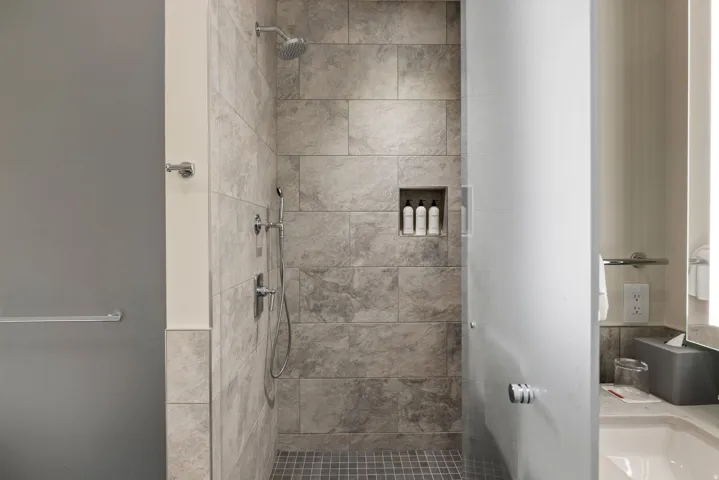Full bath featuring a stall shower and vanity