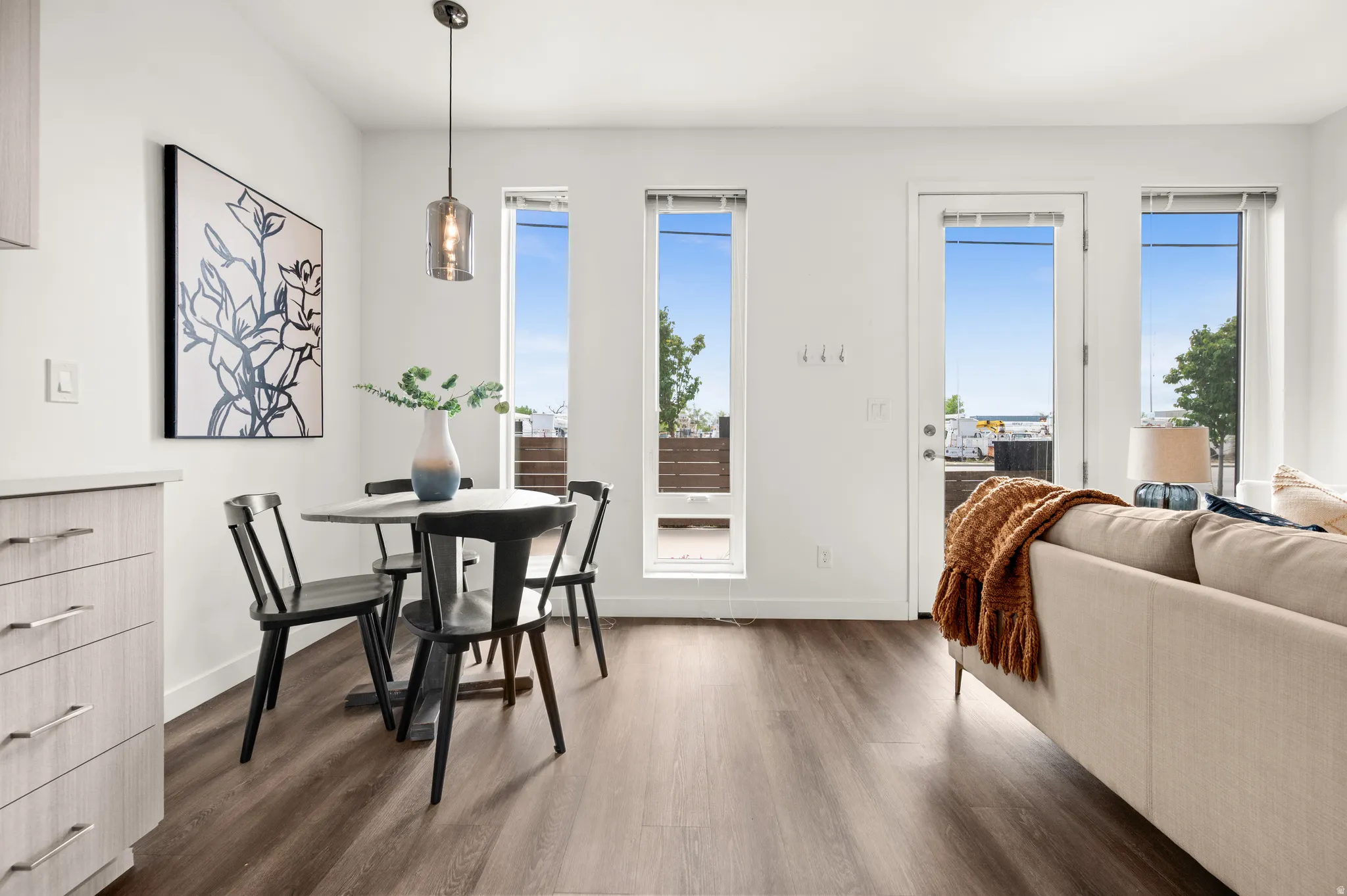 Dining area with dark wood-type flooring and baseboards