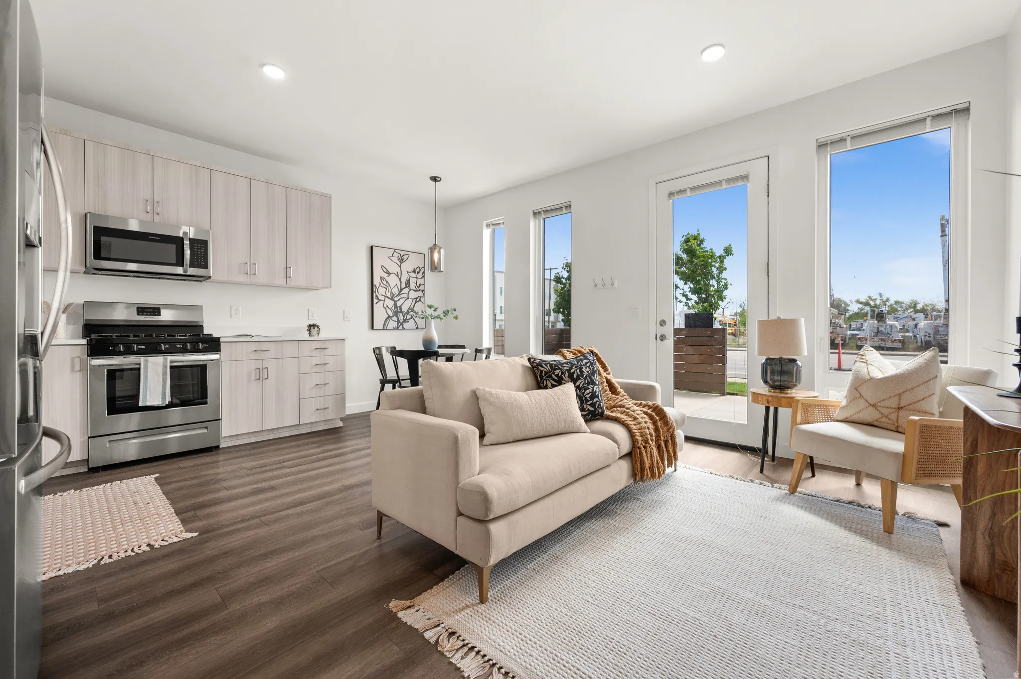 Living area with dark wood finished floors and recessed lighting