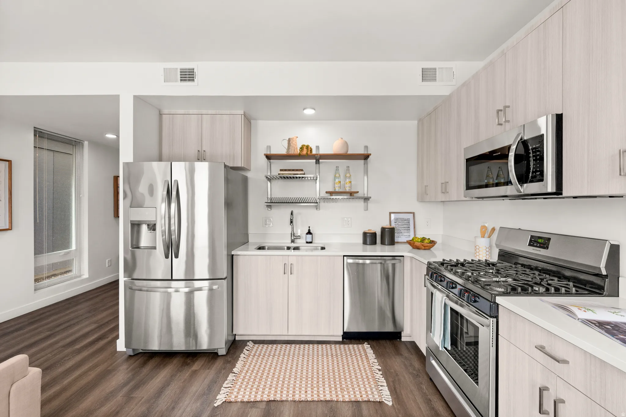 Kitchen featuring stainless steel appliances, light wood finish cabinets, open shelves, dark wood-type flooring, and recessed lighting