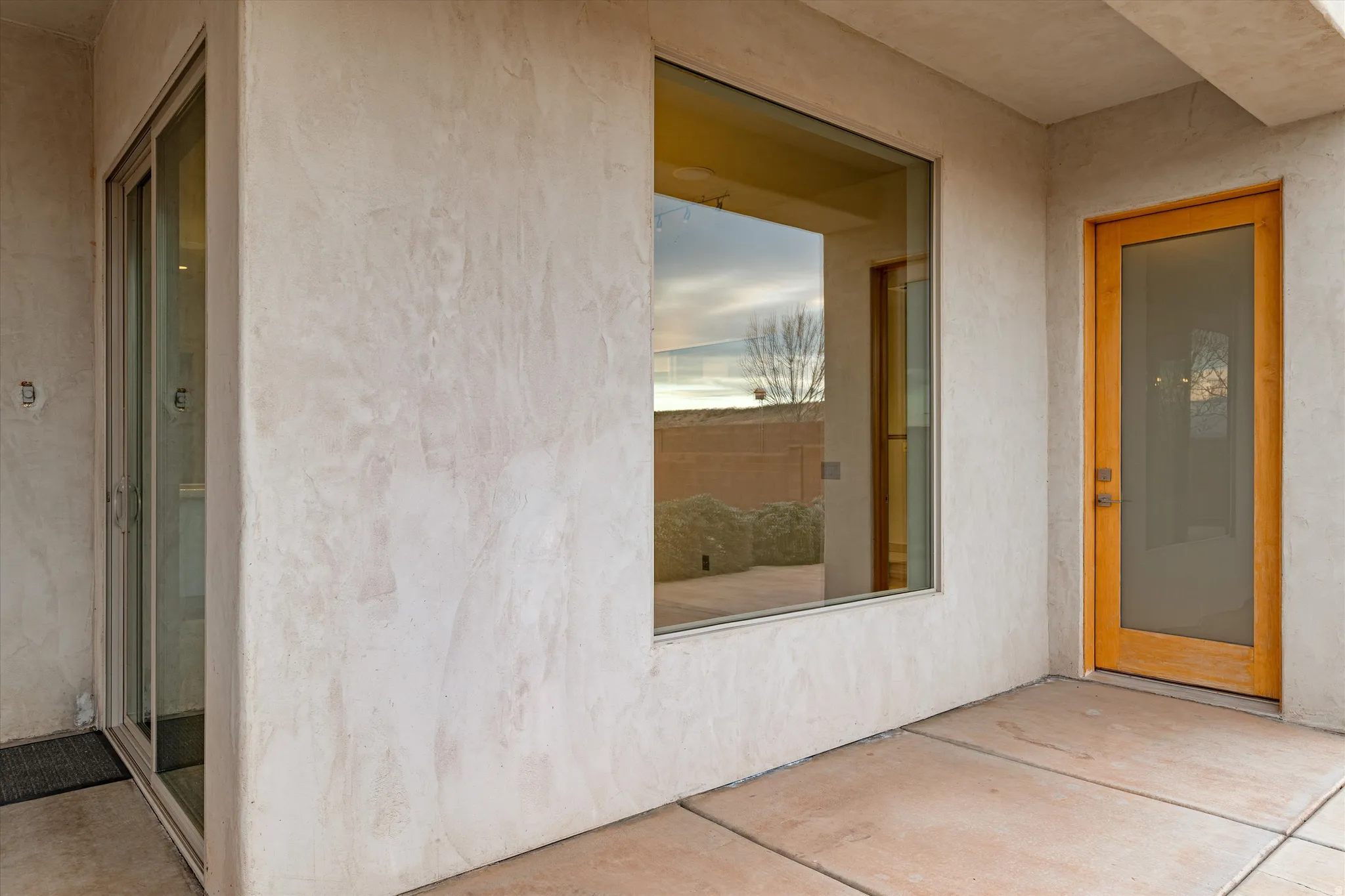 View of exterior entry featuring a patio area and stucco siding