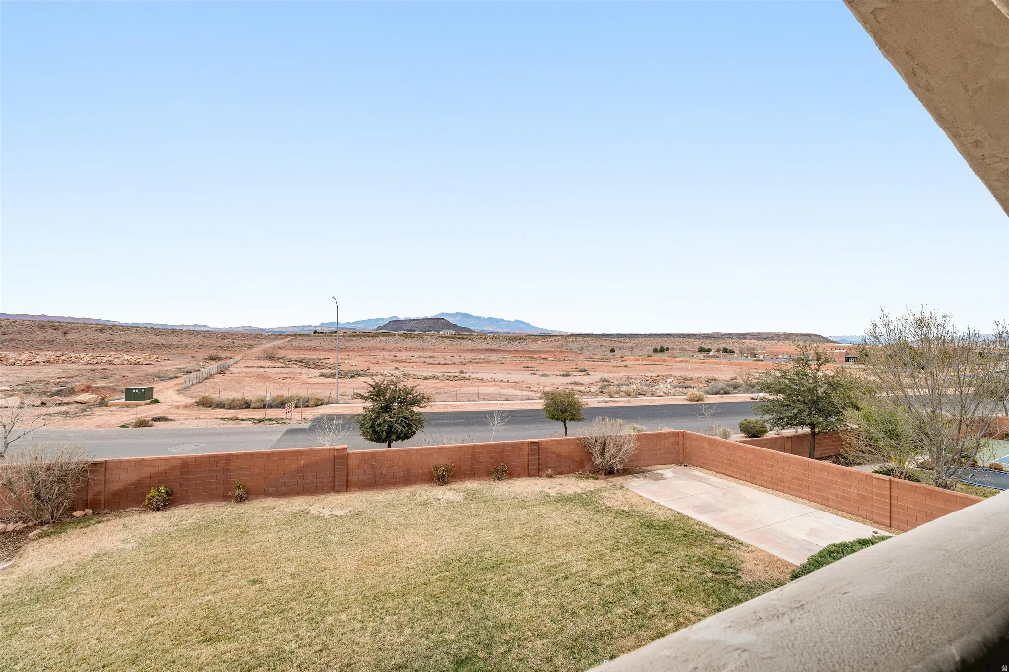 Fenced backyard featuring a mountain view, a patio area, and a view of rural / pastoral area