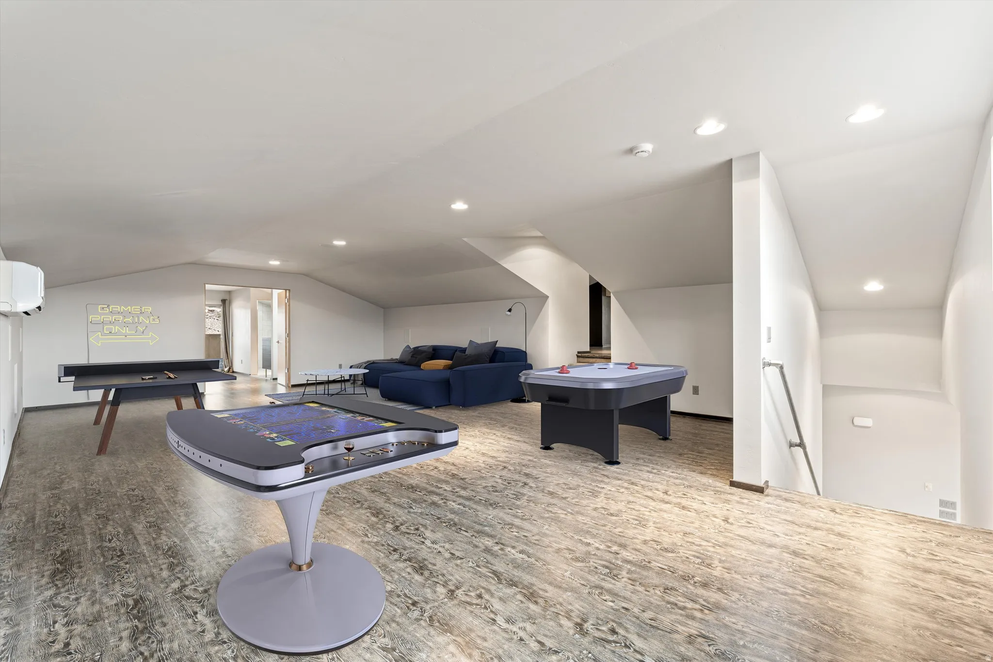 Game room with vaulted ceiling and recessed lighting