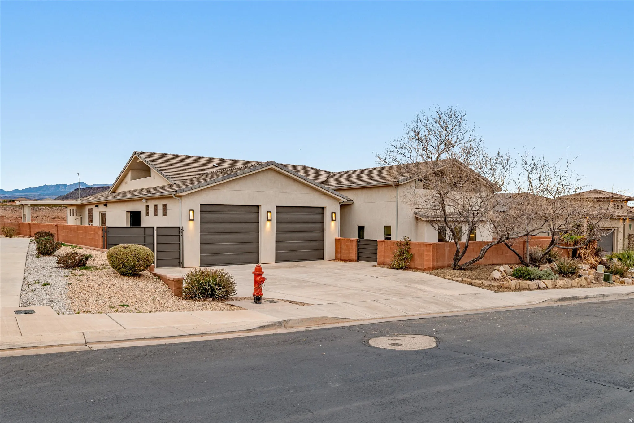 Ranch-style home with driveway, stucco siding, and an attached garage